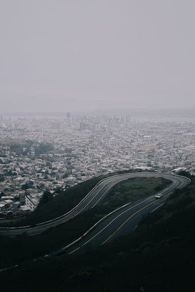 Foggy San Francisco Cityscape with Winding Mountain Road