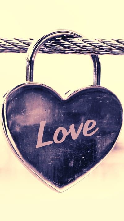 Heart-shaped padlock with the word 'Love' attached to cable