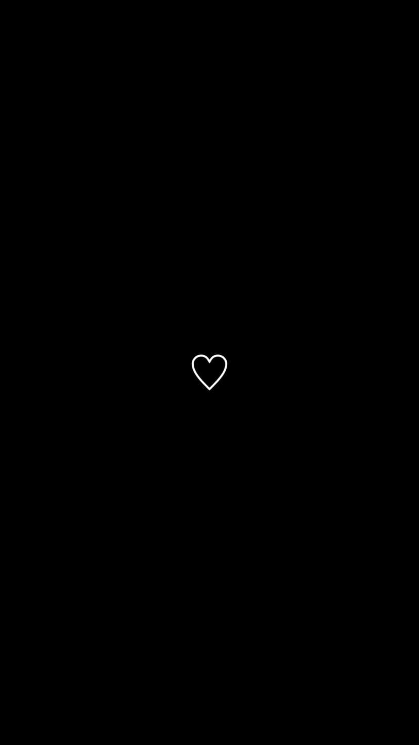 White outline heart centered on a solid black backdrop creates a high-contrast minimalist mobile background.