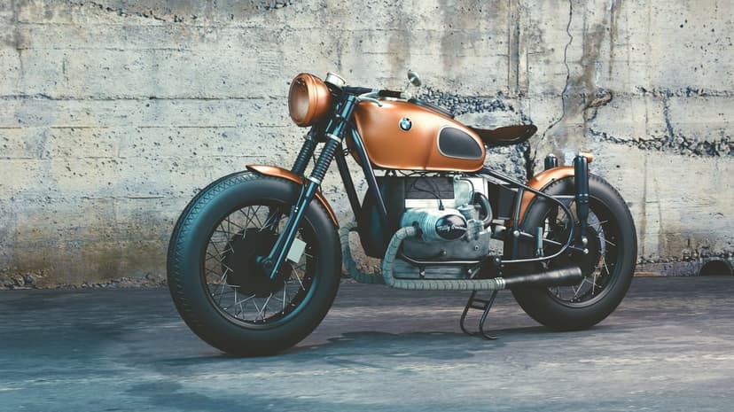 Copper BMW motorcycle with a large engine and spoked wheels stands before a textured gray concrete wall.