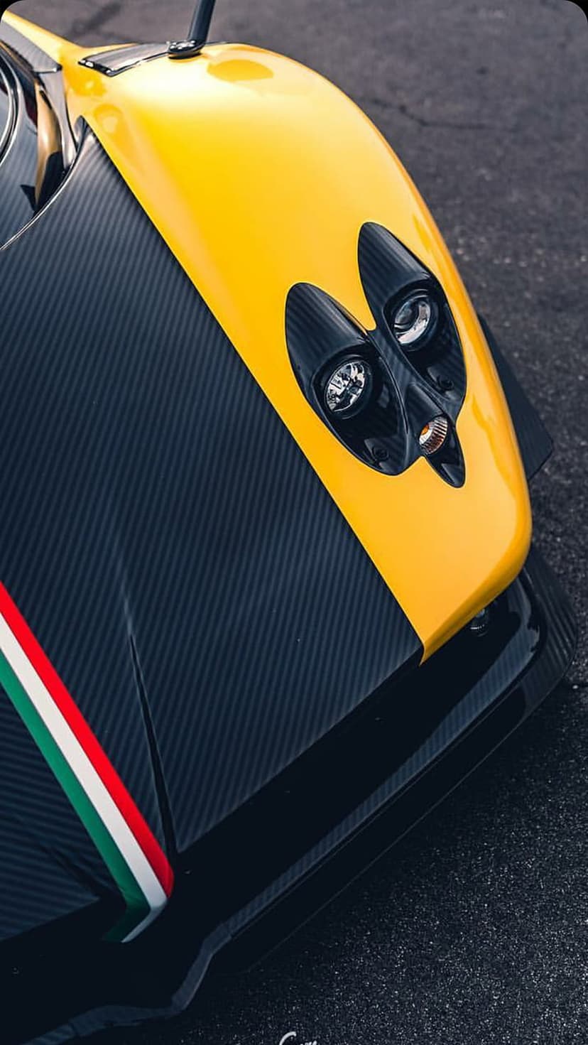 Yellow Pagani Zonda supercar front hood featuring carbon fiber panels and a tricolore Italian flag racing stripe.