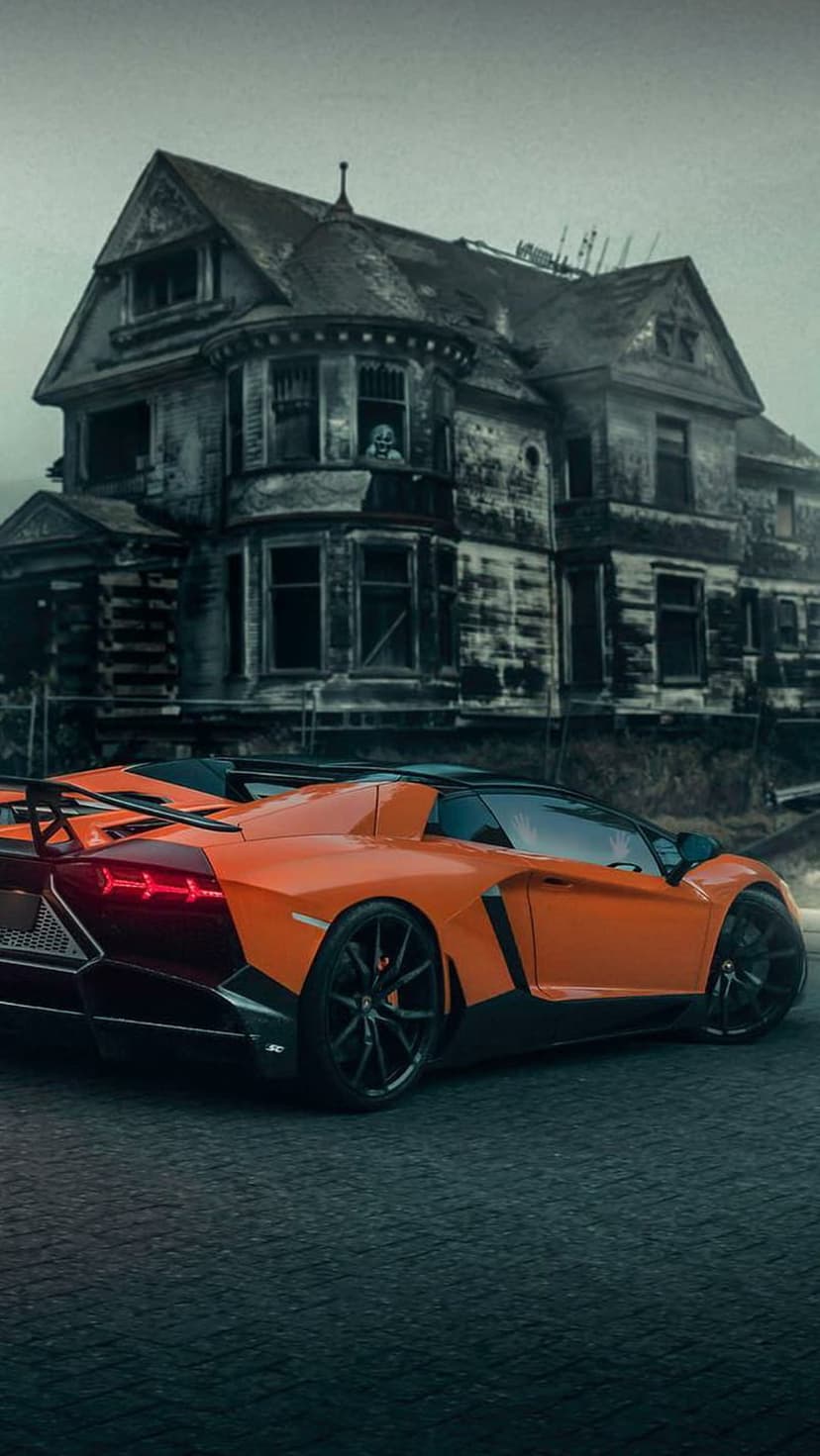 Orange Lamborghini supercar parked on overgrown grass in front of a dark, dilapidated gothic mansion.