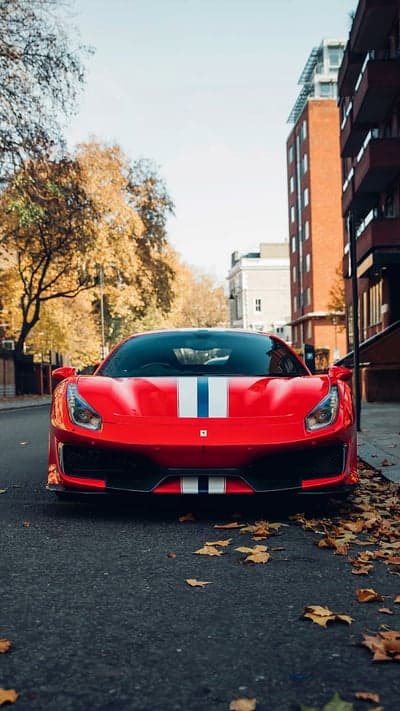 Red Ferrari Racing Stripes Autumn City Phone Background