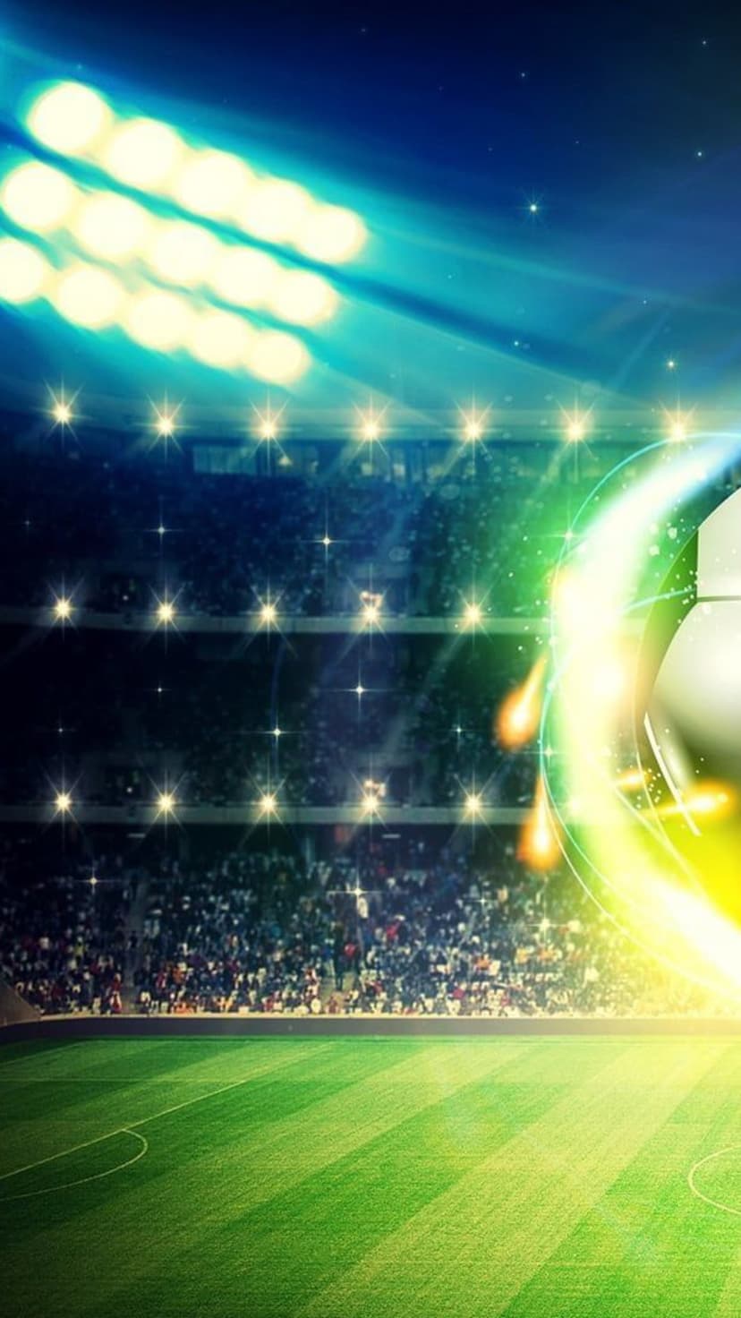 Luminous soccer ball in motion across a green field under bright stadium floodlights with a blurred crowd behind.