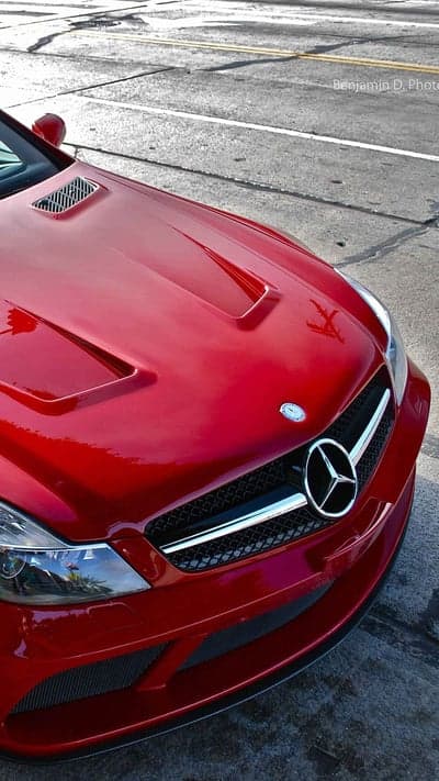 Red Mercedes-Benz SL-Class parked on asphalt street