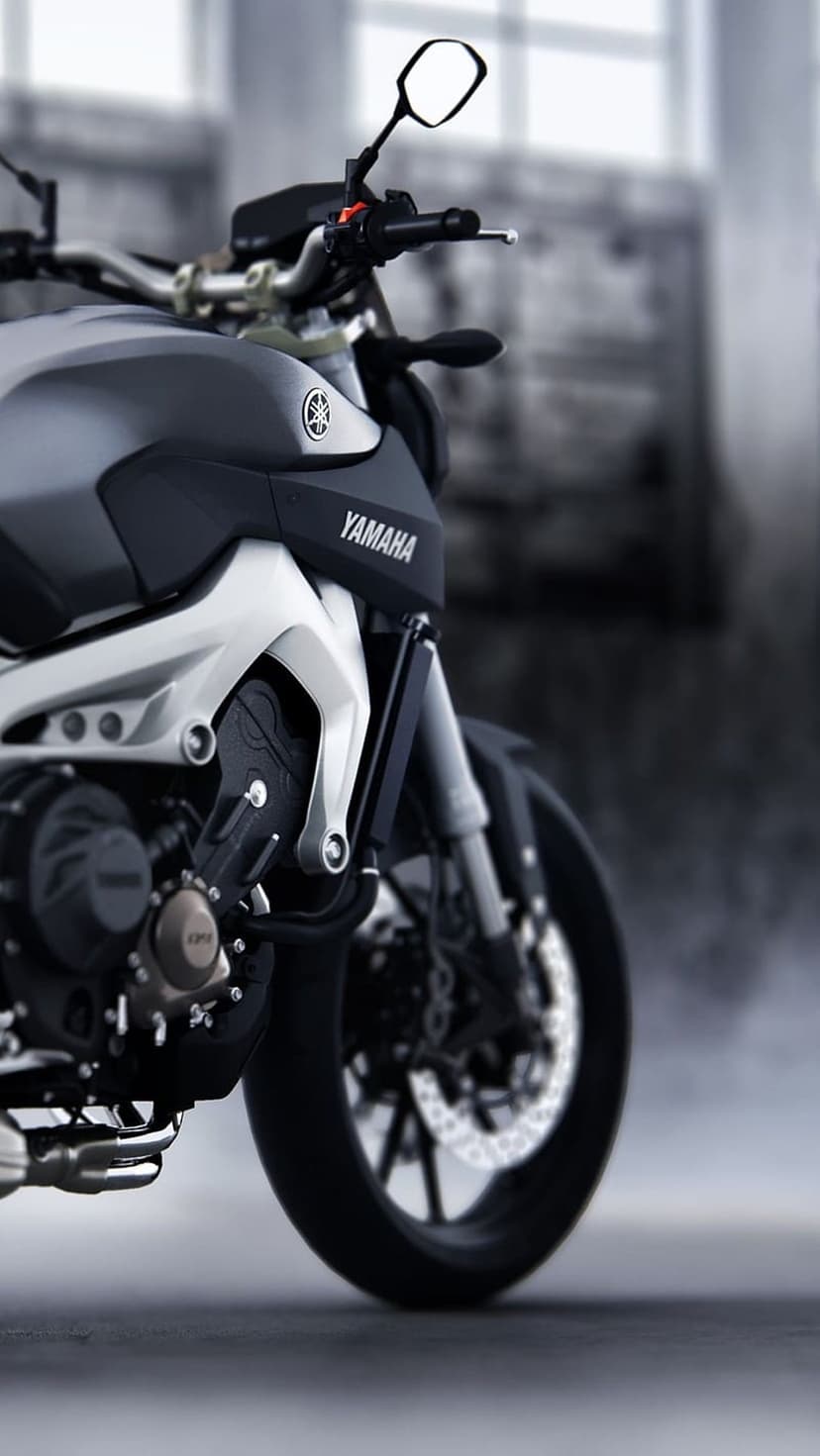 Yamaha motorcycle front end shows handlebars, brake discs, and suspension forks in high-contrast monochrome.