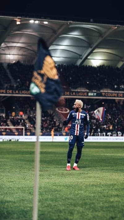 Neymar Jr. in PSG kit on the field at night