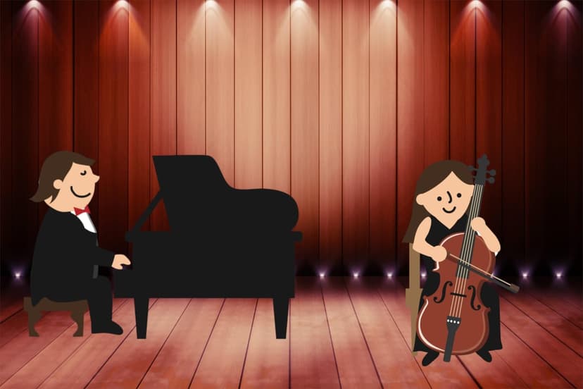Pianist and cellist perform on a warm wooden stage illuminated by overhead spotlights during a musical recital.