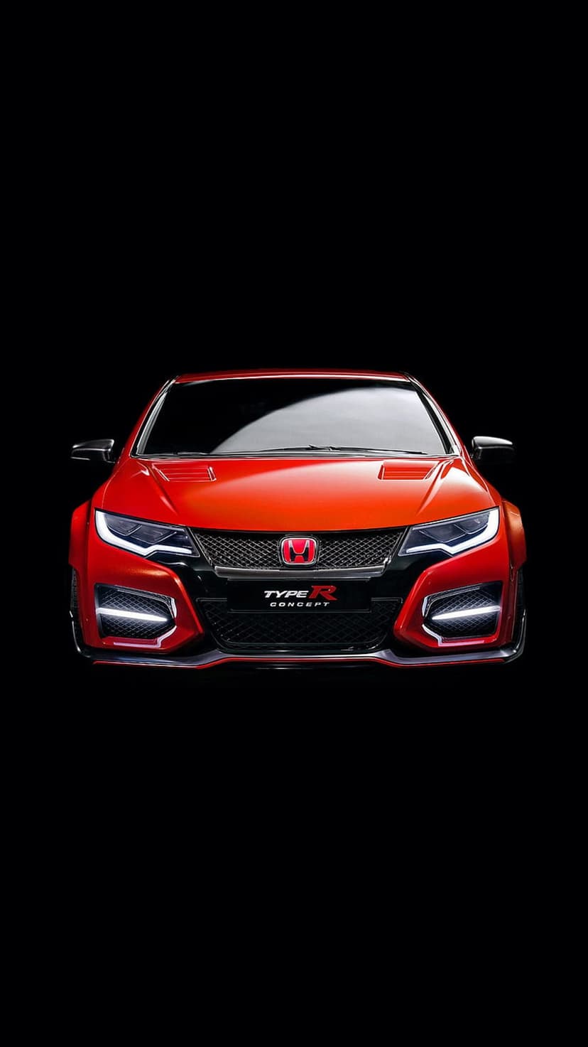 Red Honda Civic Type R concept car front view with glowing headlights and a black honeycomb grille on dark background.