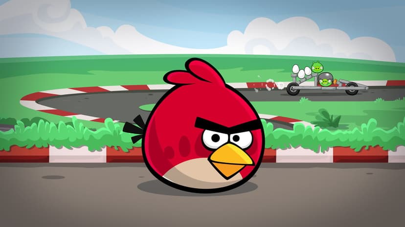 Red Angry Bird character in the foreground with green pigs racing a cart on a track with eggs behind him.