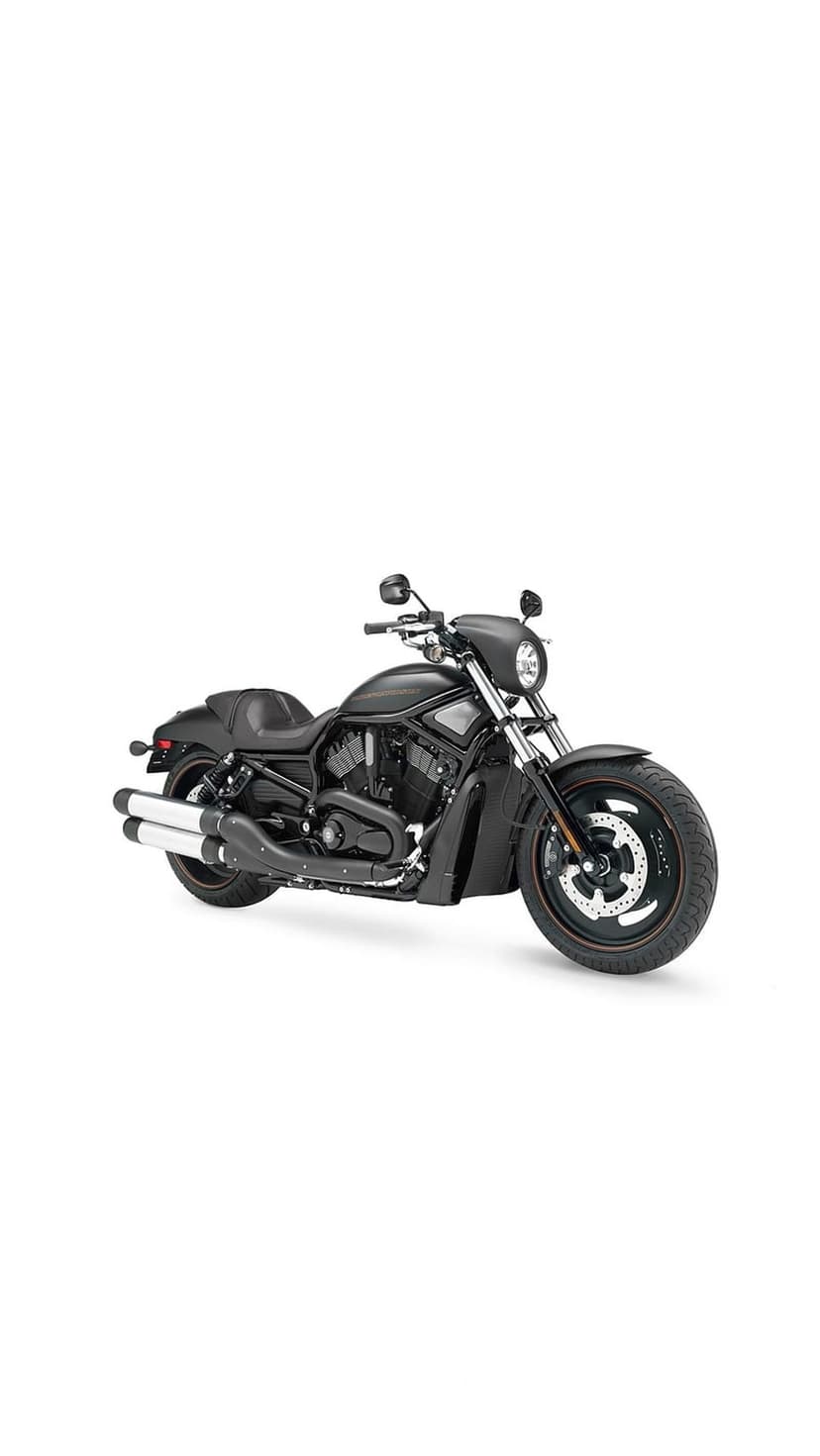 Black cruiser motorcycle featuring a detailed v-twin engine, chrome accents, and leather seat in a moody setting.