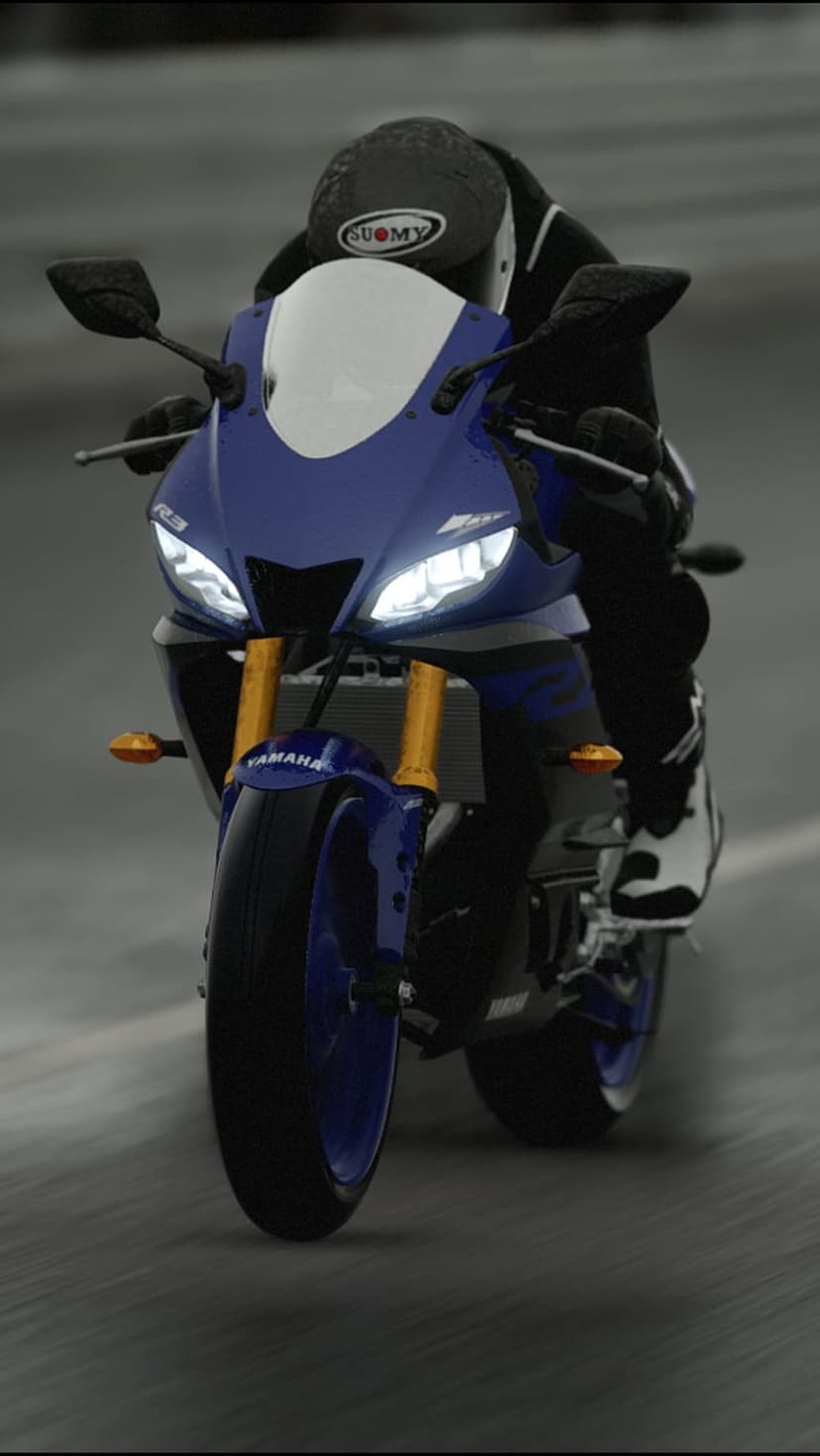 Yamaha R3 sportbike with glowing headlights speeds through a rainy street with motion blur and a helmeted rider.