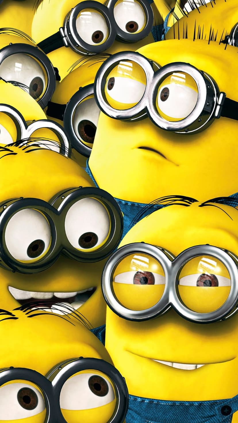 Yellow Minion characters with metallic goggles and blue overalls crowded together in a close-up portrait view.