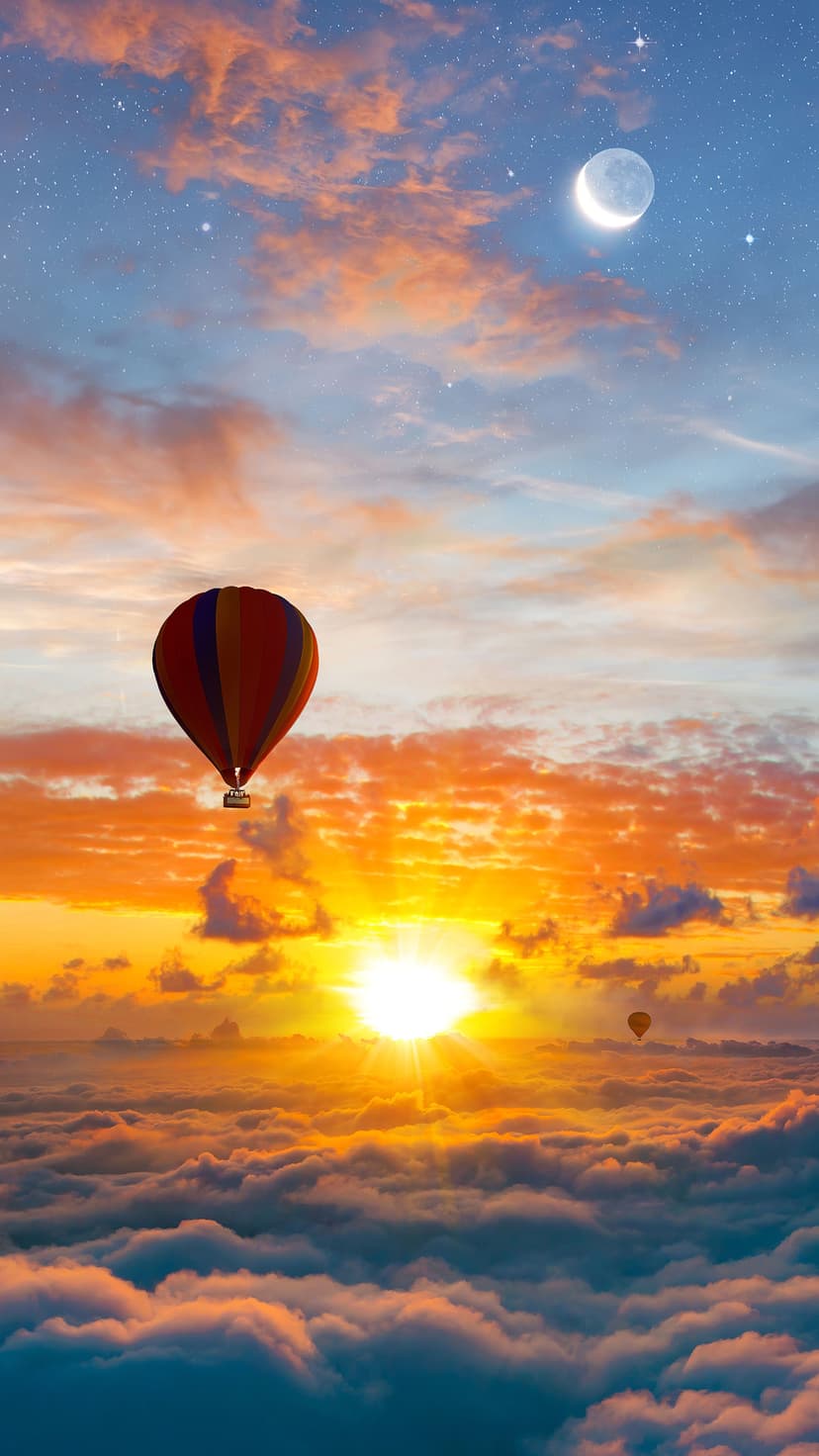 Hot air balloon with red and orange stripes soaring over a thick layer of clouds under a crescent moon at sunrise.