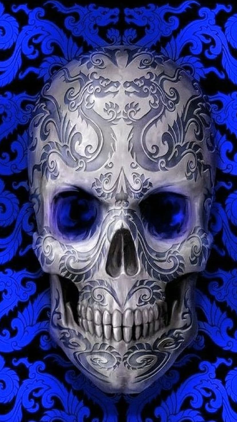 Silver skull with ornate carvings and glowing blue eyes positioned over a sapphire background with dragon motifs.