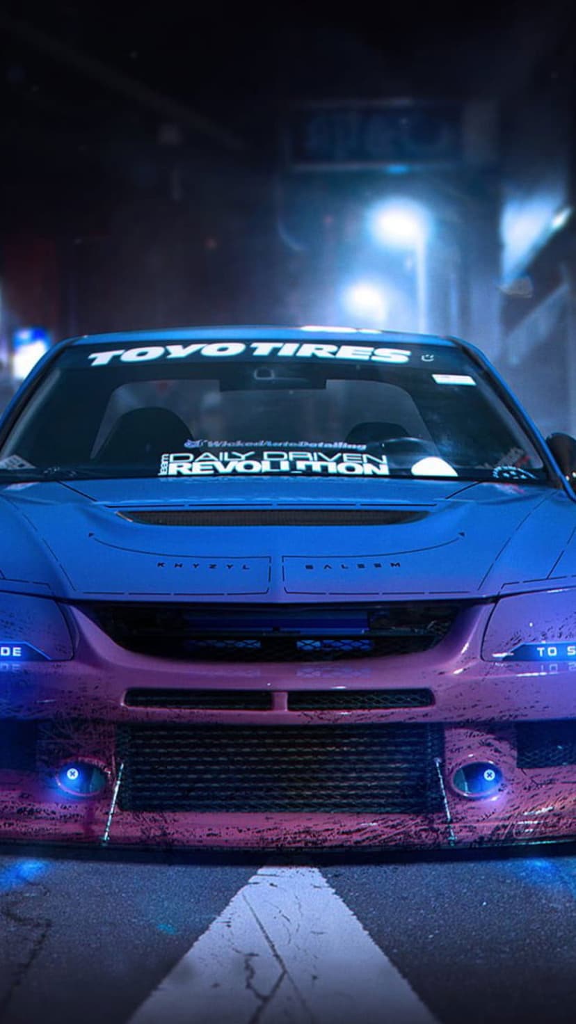 Front view of a tuned sports car under neon blue and purple street lights with Toyo Tires branding at night.