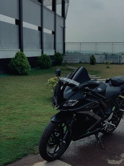 Sleek Black Sports Bike Parked on Lush Green Grass