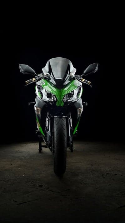 Green Kawasaki Ninja Motorcycle on Black Background