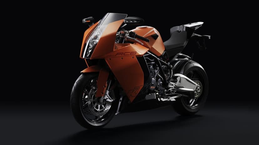 Orange and black KTM 1190 RC8 sportbike with sharp aerodynamic fairings on a solid black studio background.