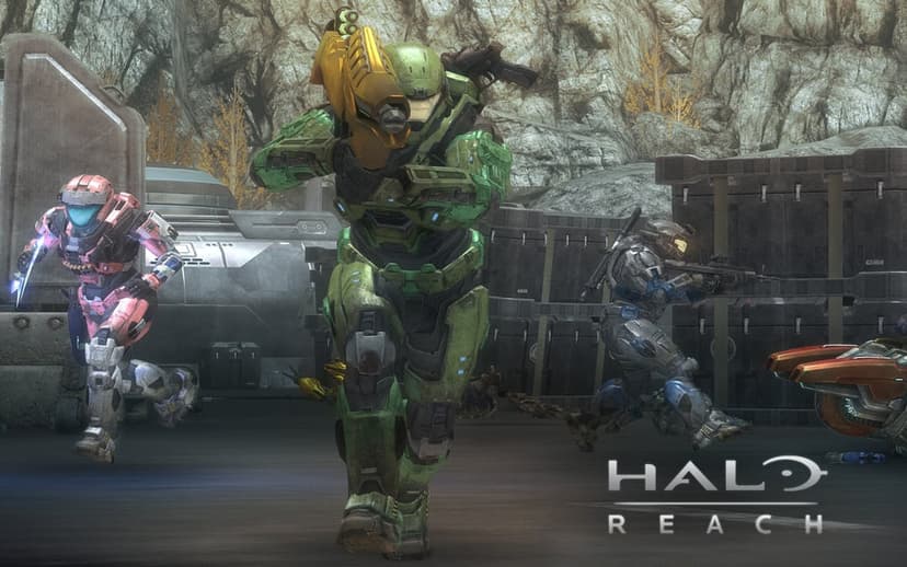 Three Spartans in colored MJOLNIR armor engage in combat across a rocky industrial Halo: Reach landscape.