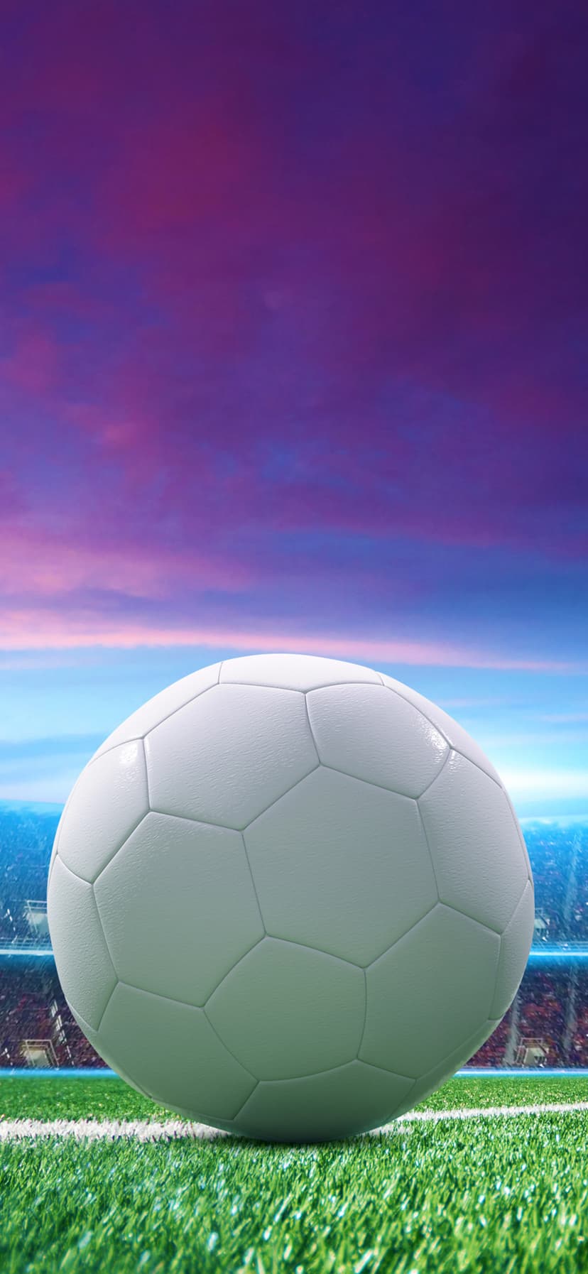 Soccer ball on a green grass field with a stadium and a vibrant purple sunset sky in the background.