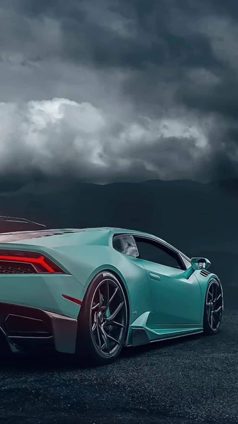 Teal Lamborghini Huracan with glowing red taillights parked on asphalt under a dramatic, dark stormy cloudscape.