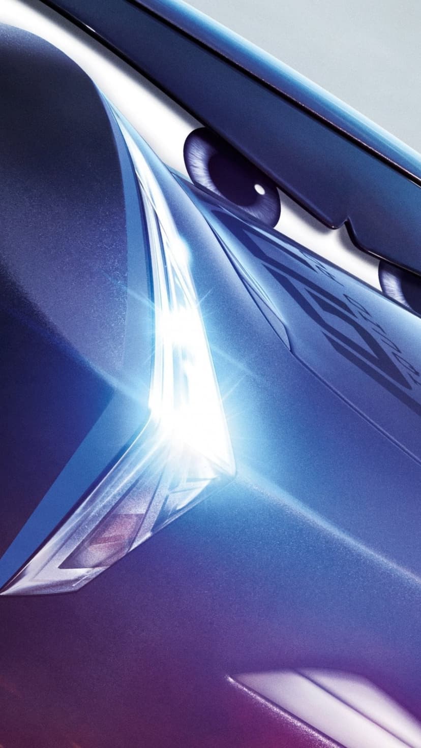 Lightning McQueen features a glowing white headlight and bright blue eye iris on a metallic car body.