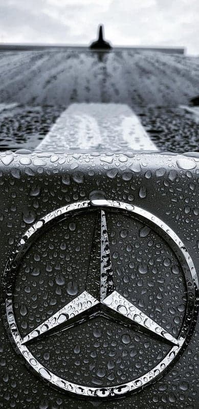 Monochrome Mercedes Star Logo with Water Droplets Background