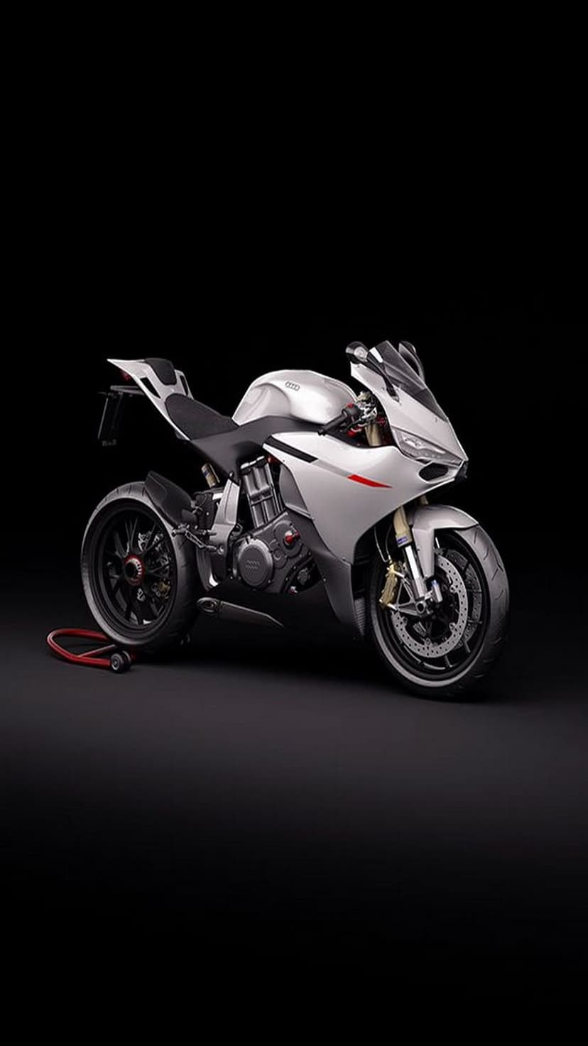 Silver sportbike with red accents and visible engine parts positioned against a solid black studio background.