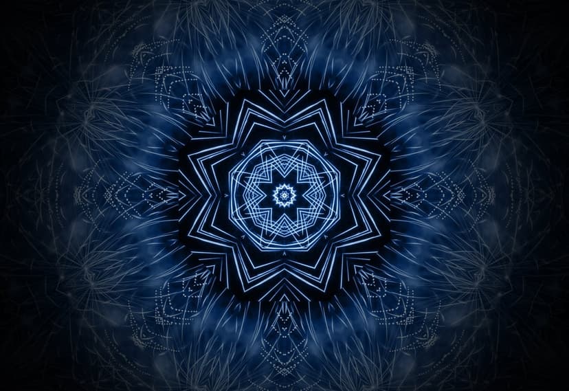 Luminous blue mandala with intricate geometric fractals radiating from a bright center against a dark background.