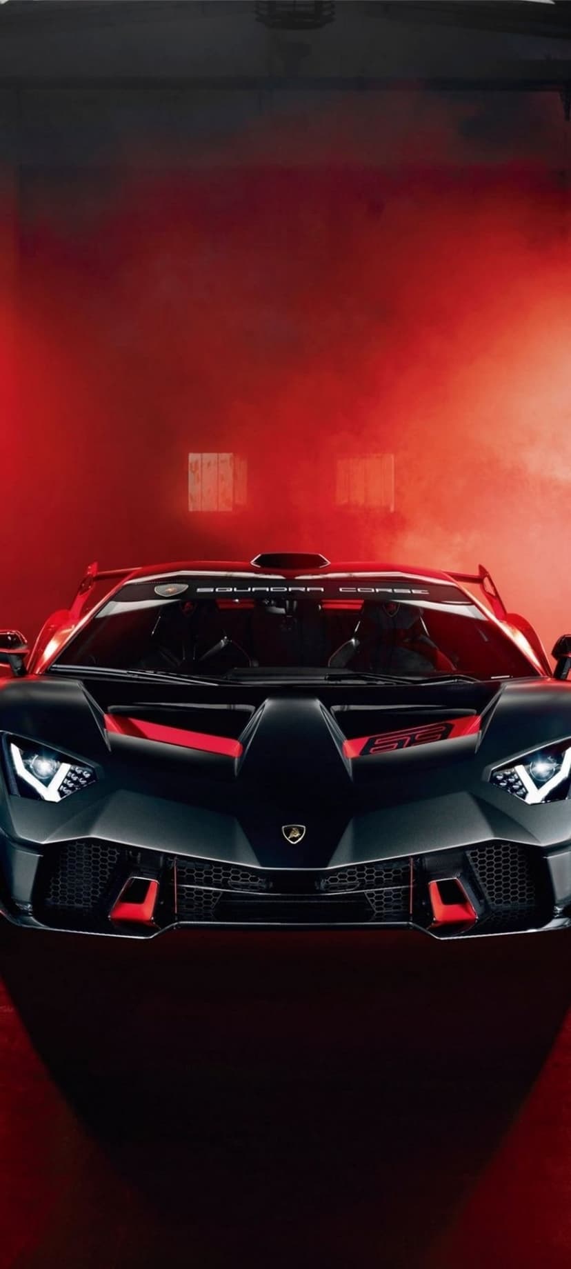 Lamborghini Squadra Corse hypercar with red accents parked in a thick cloud of dramatic crimson smoke.