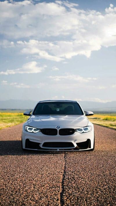 White BMW M4 Sports Car Mountain Road Phone Wallpaper