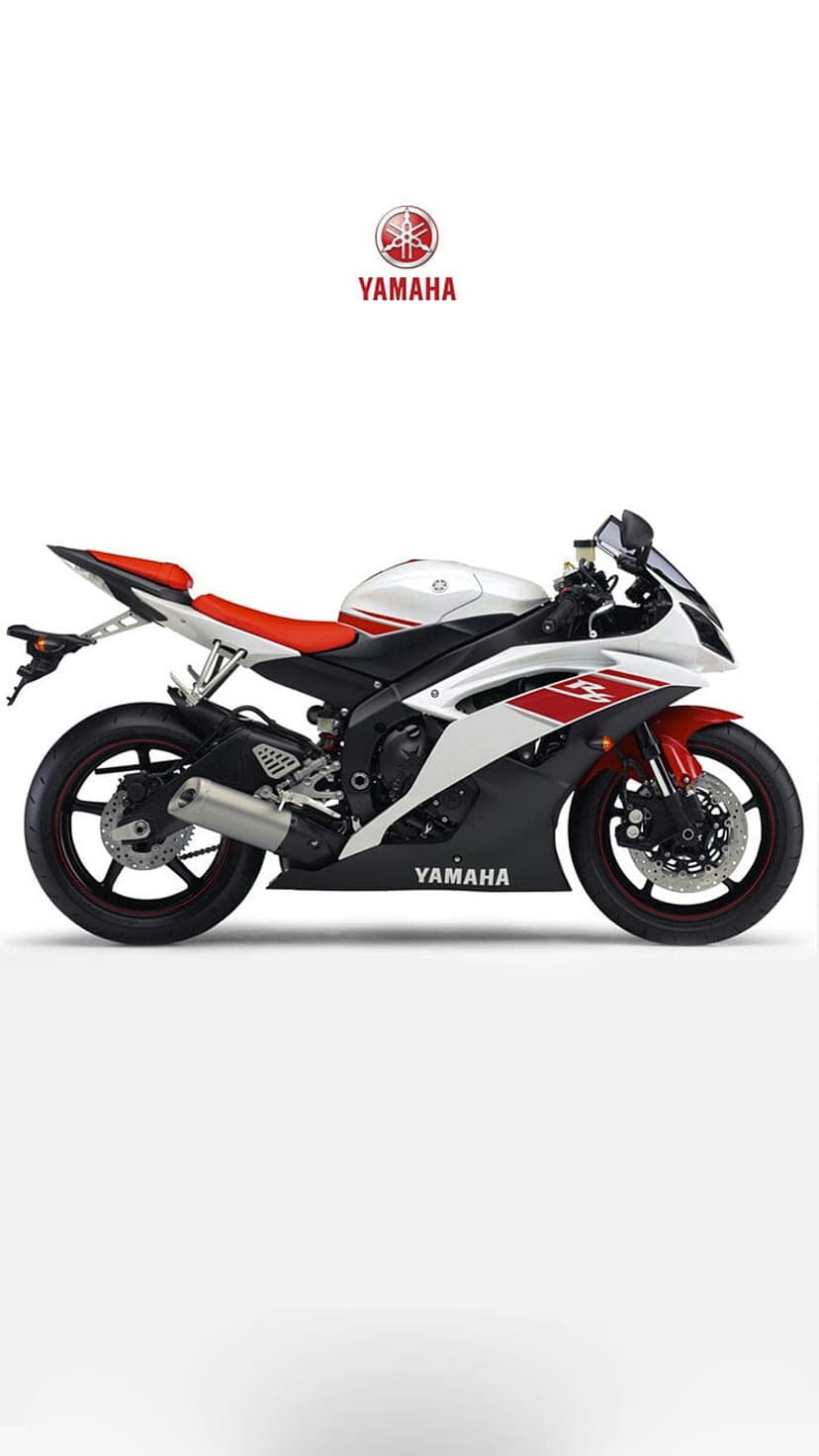 Yamaha R6 sportbike with white fairings and a red seat positioned against a solid white studio background.