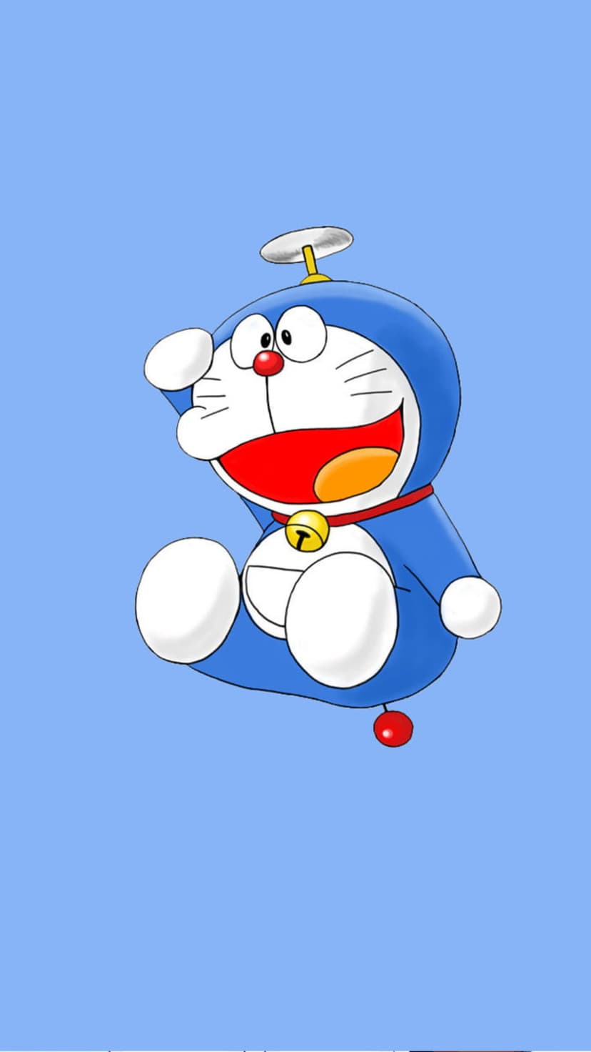 Doraemon sits with a yellow propeller on his head, waving a white paw against a solid light blue background.