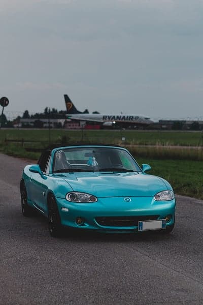 Turquoise Mazda Miata Convertible and Ryanair Plane
