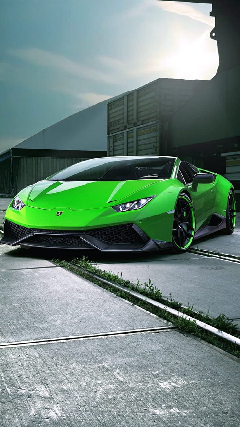Bright green Lamborghini Huracan parked on concrete near blue cargo containers under a clear afternoon sky.