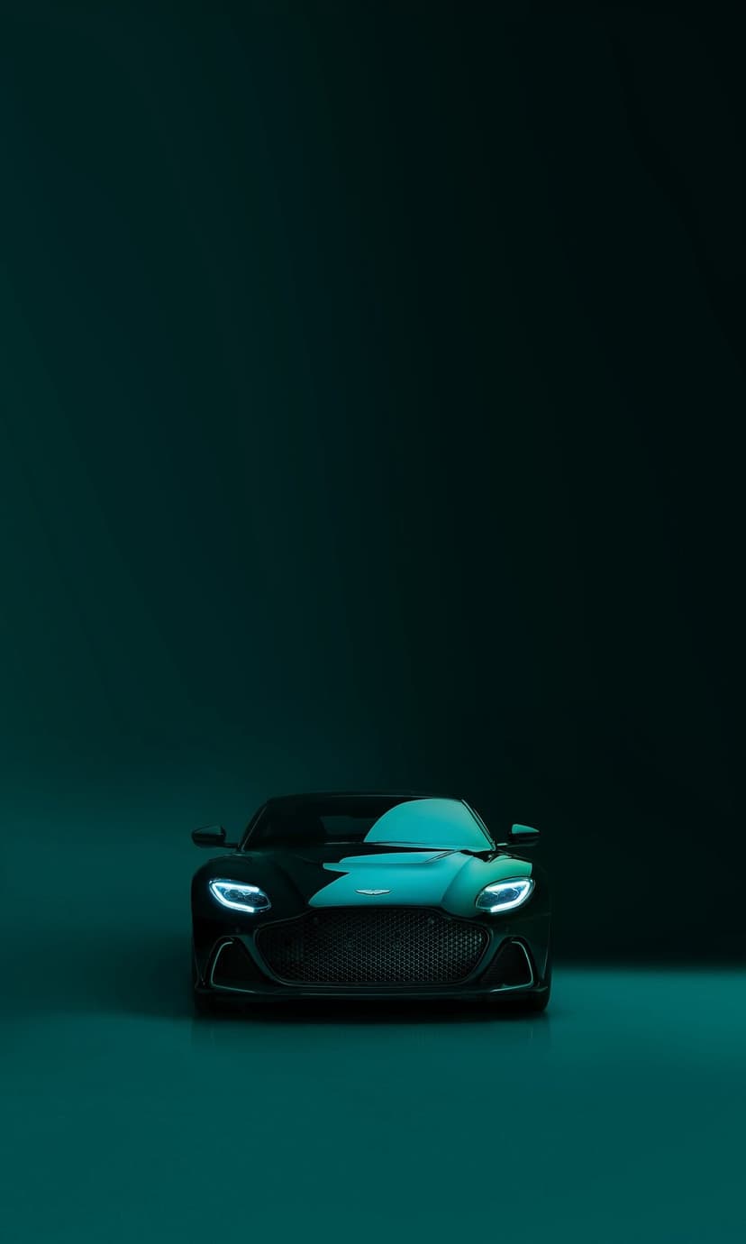 Black Aston Martin DBS Superleggera with glowing LED headlights and teal lighting accents on a dark background.