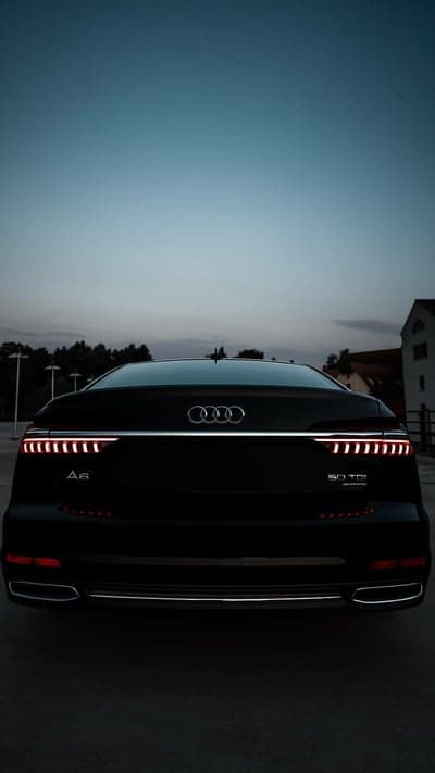 Black Audi A6 50 TDI rear view at dusk