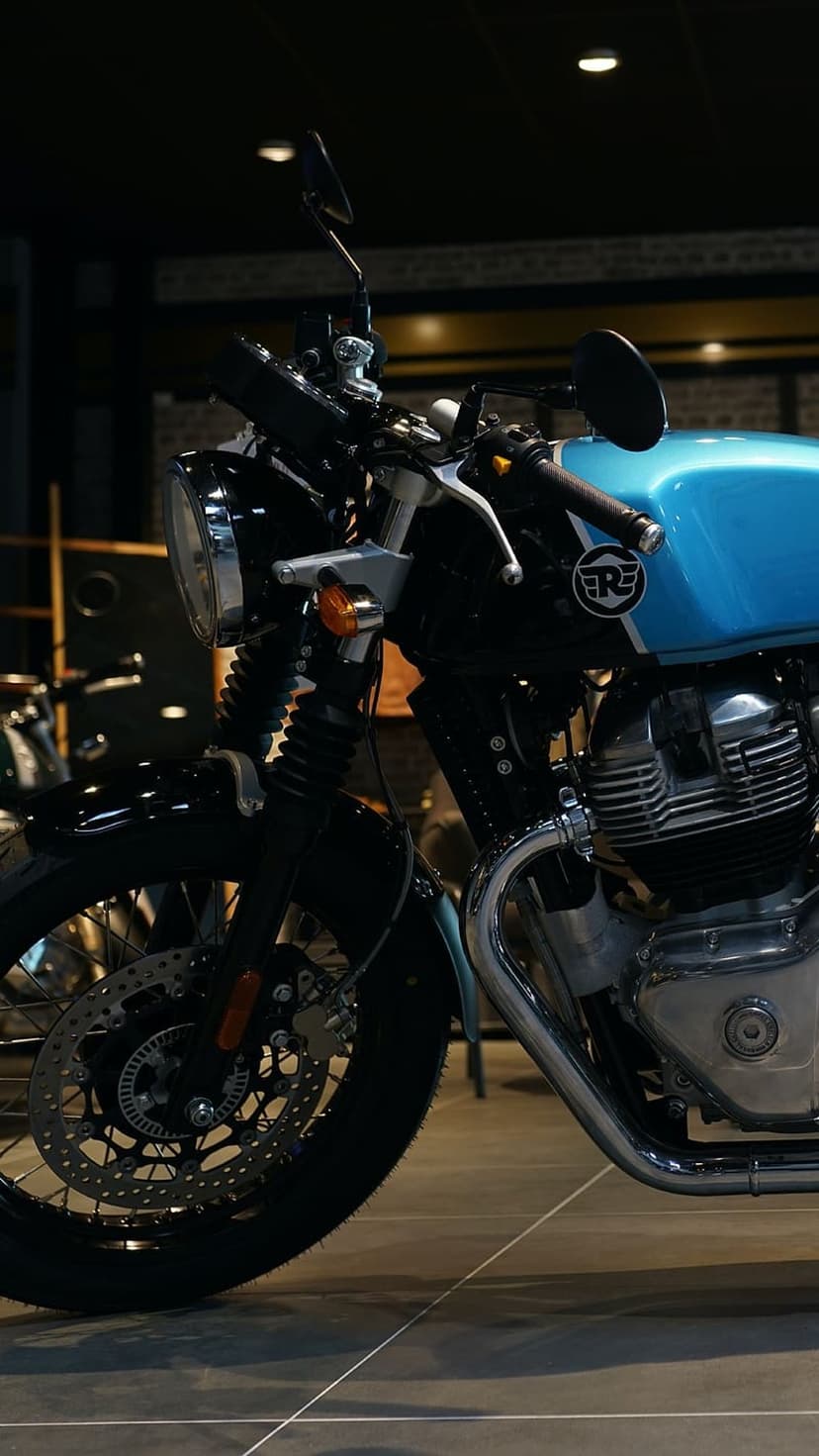 Royal Enfield Interceptor 650 motorcycle featuring a blue fuel tank, chrome engine parts, and front disc brake.