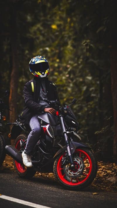 Rider in Helmet on Motorcycle in Forest