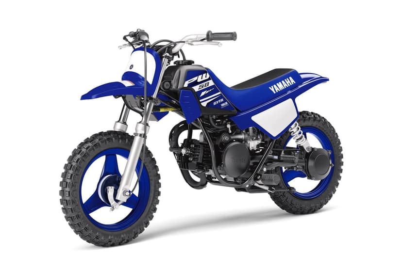Blue Yamaha PW50 mini dirt bike with knobby tires and white plates on a clean white studio background.