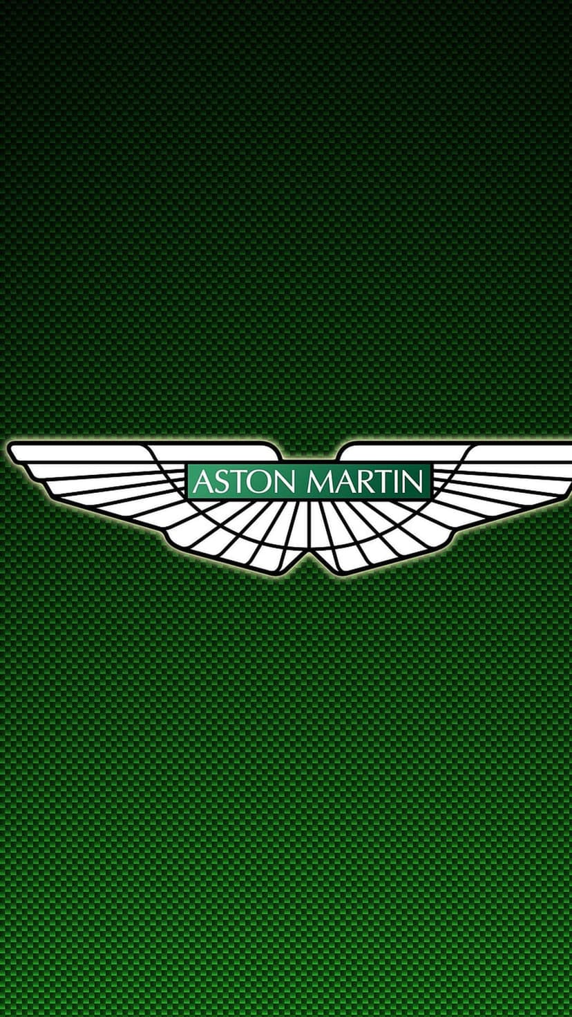 Aston Martin silver wings logo centered on a textured dark green carbon fiber background with diagonal weaves.