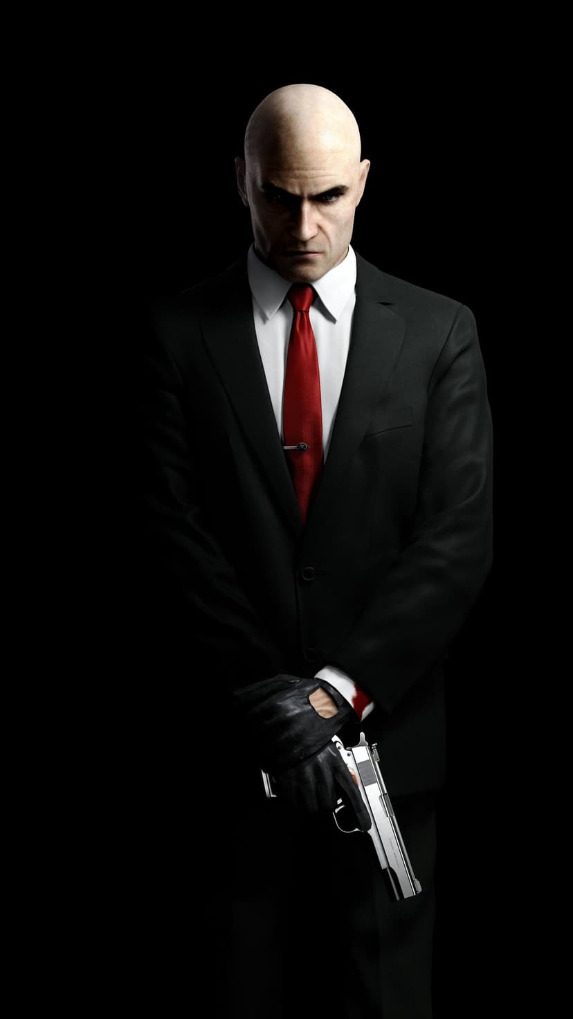 Bald man in black suit and red tie holding a silver pistol against a black background with dramatic lighting.