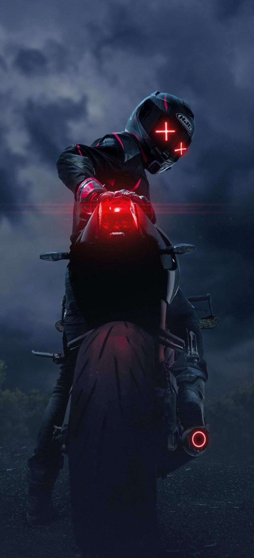 Motorcyclist in a black suit wears a helmet with red glowing lines while sitting on a bike under a dark cloudy sky.
