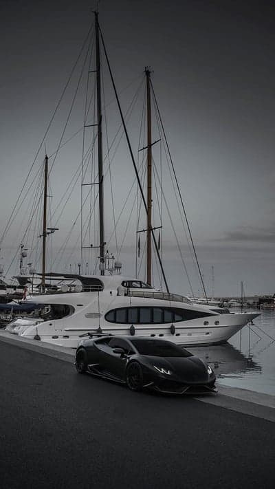 Luxury Yacht and Black Sports Car Dockside Scene