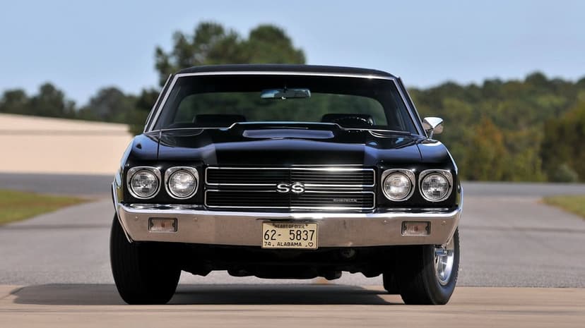 Front view of a black 1970 Chevrolet Chevelle SS with chrome bumpers and dual headlights on an open road.