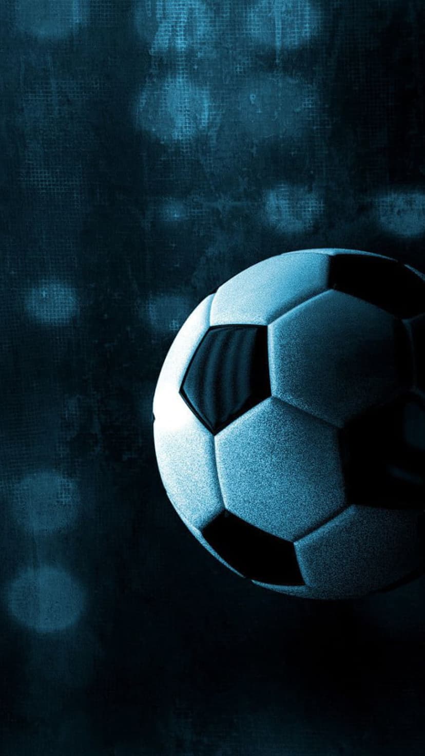 Soccer ball with blue highlights sits against a dark textured backdrop featuring soft out-of-focus bokeh lights.