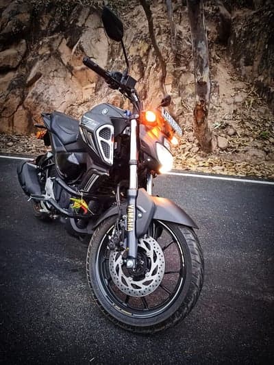 Yamaha Motorcycle on Scenic Road with Rocky Hillside