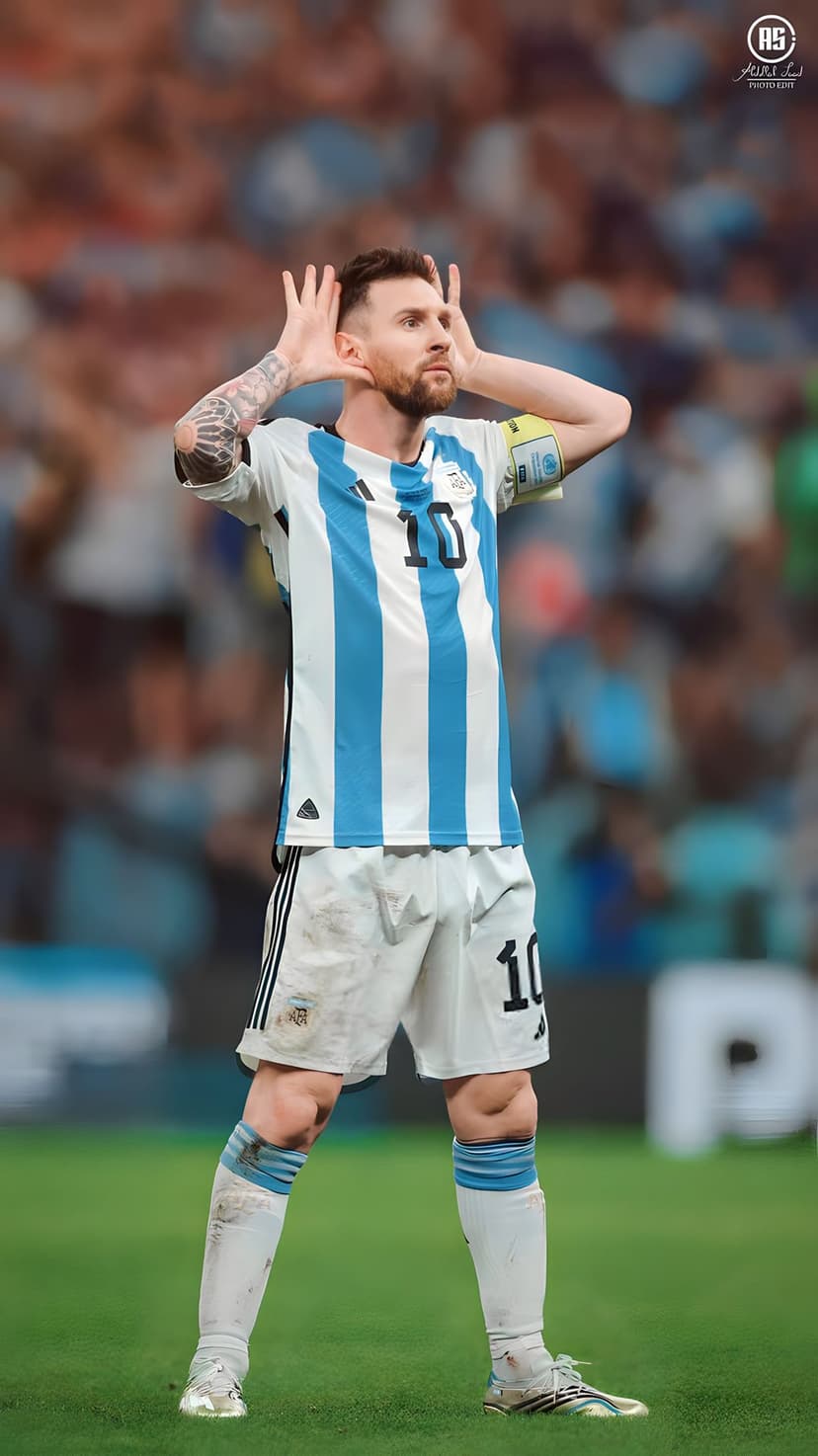 Lionel Messi in a blue and white Argentina jersey celebrates a goal with fingers pointed toward the sky.