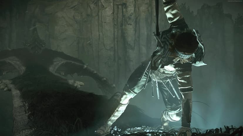 Wander hanging from dark fur against a rocky cliff with moody green lighting in Shadow of the Colossus.